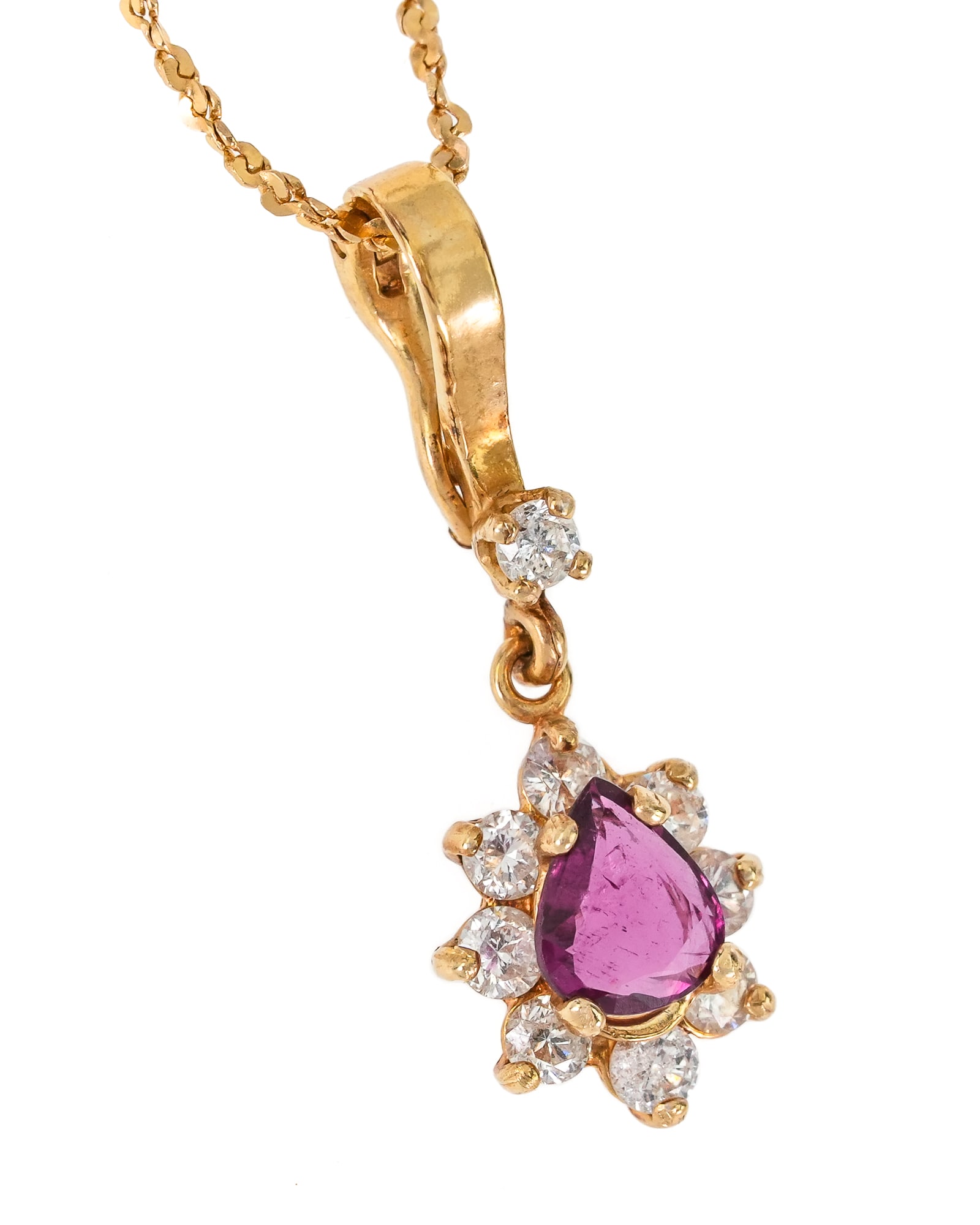 Ruby & Diamond Pendant: 14k yellow gold chain with a pendant having a .65 ct tear drop cut ruby with a 8 .04 ct round cut diamond surround and a .04 ct round cut diamond set in loop above pendane. 3.67 grams t.w.