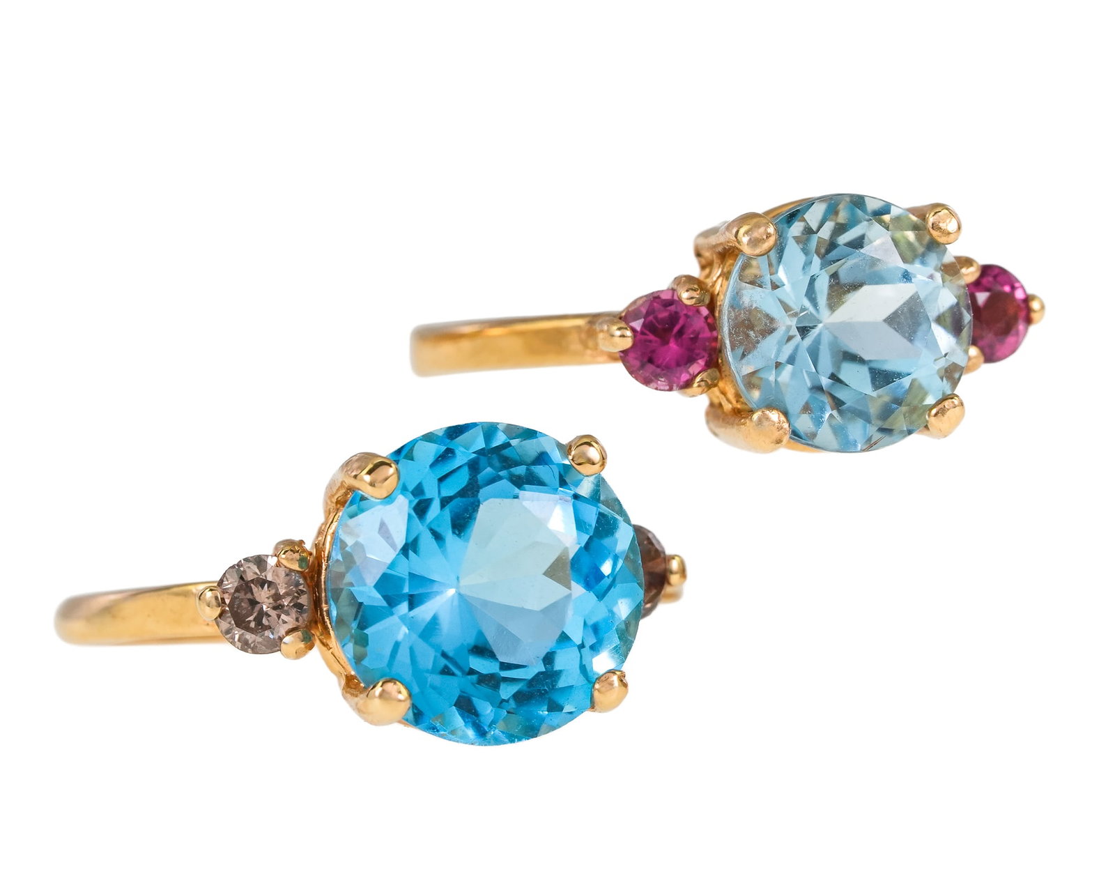 2 14k 3 Stone Rings: 2 14k yellow gold rings. One 3 stone ring with center round cut 4 CT blue topaz with 2 .04 ct round cut diamonds, ring size 7. Second 3 stone ring with center round cut 2 CT aquamarine with 2 .06 ct