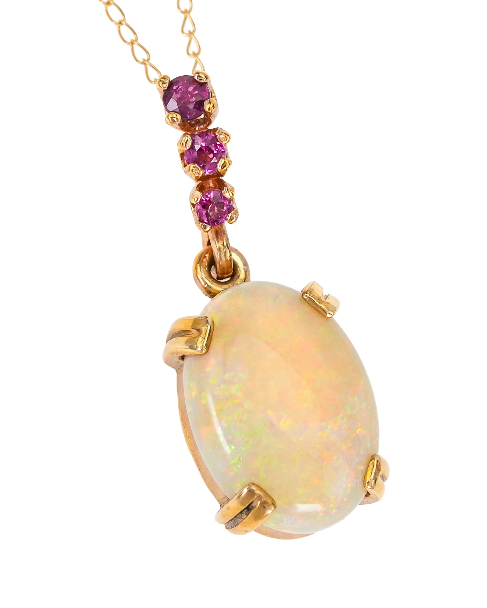 14k Opal & Ruby Pendant: 14k yellow gold necklace with a polished oval opal measuring 4 x 9.5 x 14 mm. With graduated round cut rubies approx .03 to .05 cts each. 3.35 grams t.w.