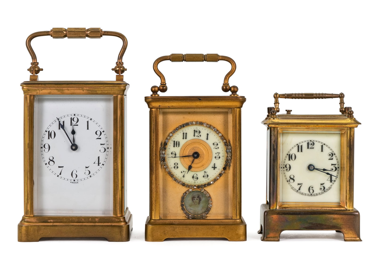 Three Ca 1900 Brass Carriage Clocks: Three ca 1900 brass carriage clocks- Duverdry & Bloquel France, eleven jewels, ht with handle 6 3/4", H & H France with simulated diamond surround and small porcelain portrait, ht with handle 5 3/4",