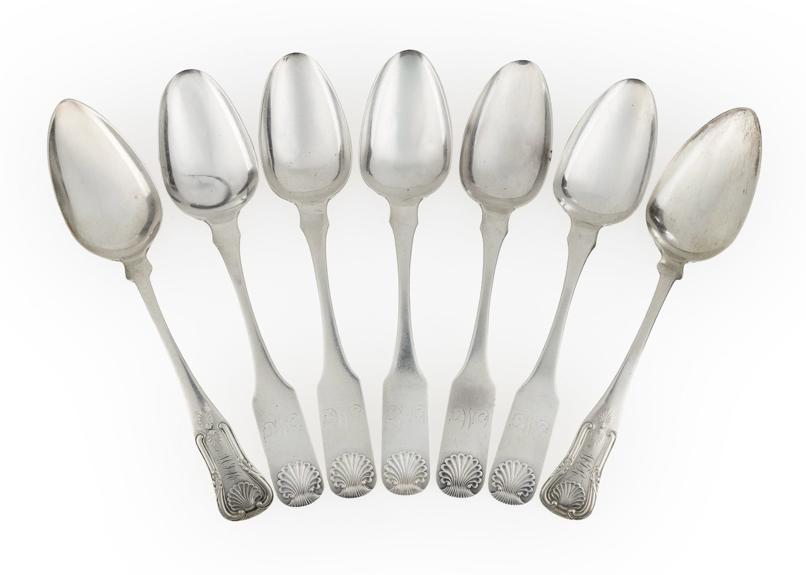 7 Coin Silver Shell Decorated Tablespoons: Seven 19th c. early American coin silver tablespoons including 5 Thibault and Brothers Philadelphia, PA shell decorated spoons with cursive "M" monogram, and two Thibault and Brothers Georgian motif s