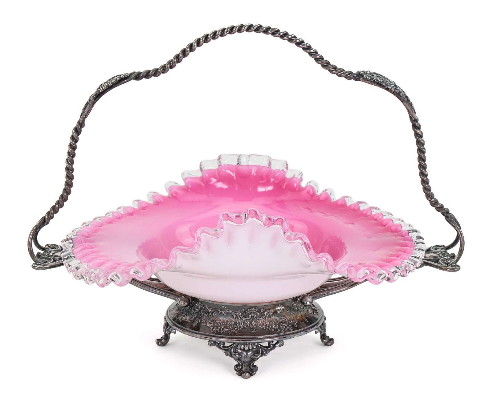 Victorian Pink Cased Glass Bride's Basket: Victorian pink cased ruffled art glass 'bride's basket' centerpiece bow in silver plated frame marked "The Meriden Silverplate Co." Overall good condition. 10" x 14"