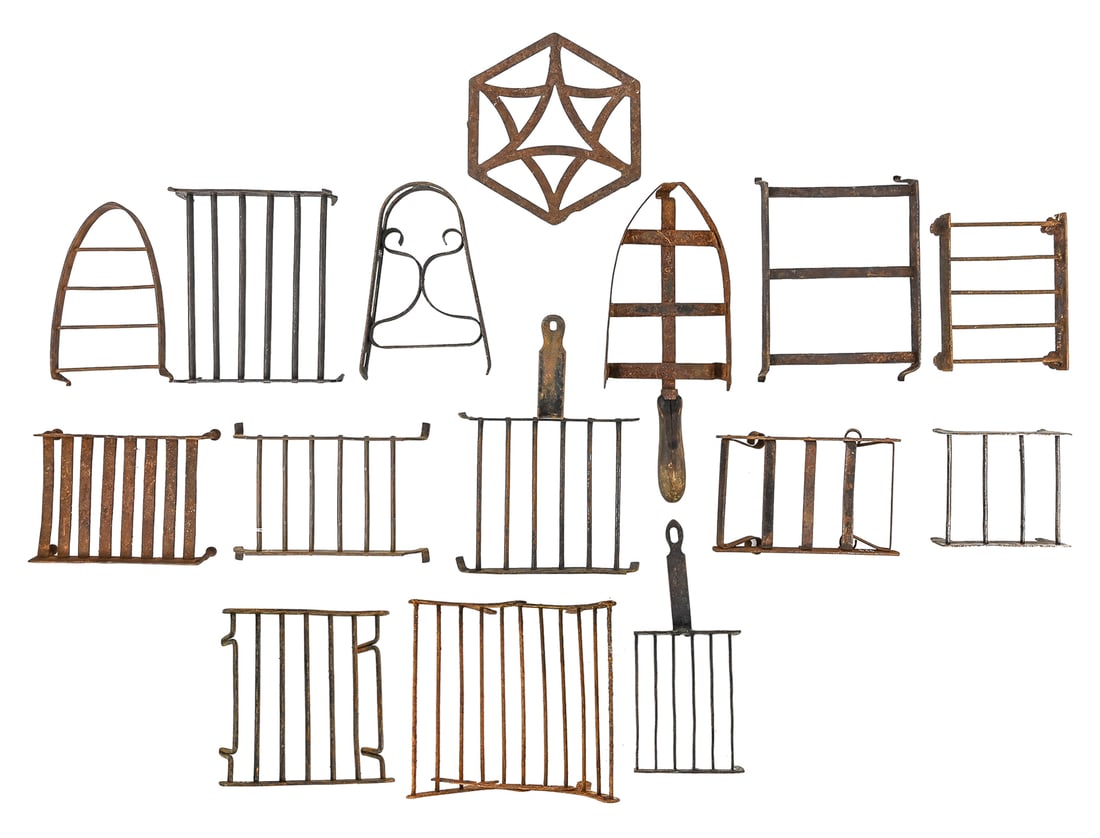 Group of 15 18thc & 19th c Wrought Iron Trivets: Fifteen 18thc & early 19thc wrought iron trivets including wire pot and spade-shaped examples, most with three or four legs. Largest is 9" L with a hinged center, folding and locking lever to adjust
