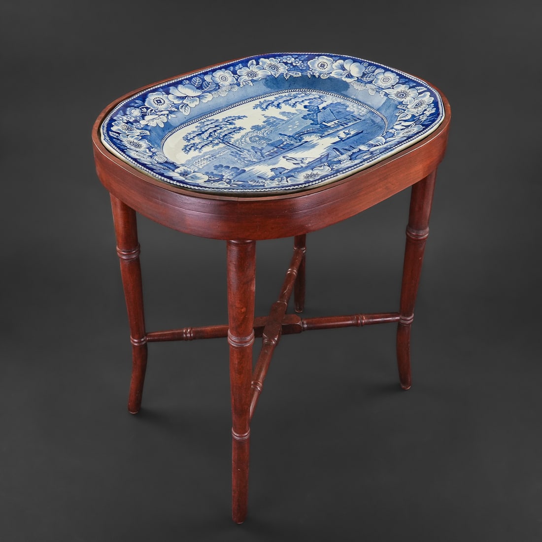 Blue Staffordshire Porcelain Platter End Table: 19th c. blue Staffordshire transferware porcelain serving platter having scenic decoration of bridge over river with boatmen, inscribed on reverse 'Wild Rose", accompanied by a custom made Chinese Chi