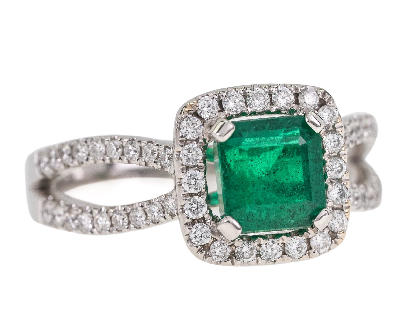 18k, Emerald, & Diamond Ring: 18k white gold ring set with a natural 1.25 ct emerald cut emerald ring. Having a small diamond surround and a double loop band set with small diamonds. 56 diamonds, approx. .75 cts.t.w. diamonds. Rin