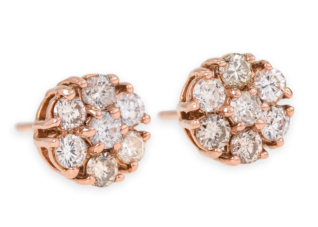 Diamond Flower Stud Earrings: A pair of 14k rose gold floral for stud earrings set with 7 .05 ct round cut diamonds, one in center and 6 in surround. 1.5 grams t.w. Approx. .7 cts.t.w. diamonds.