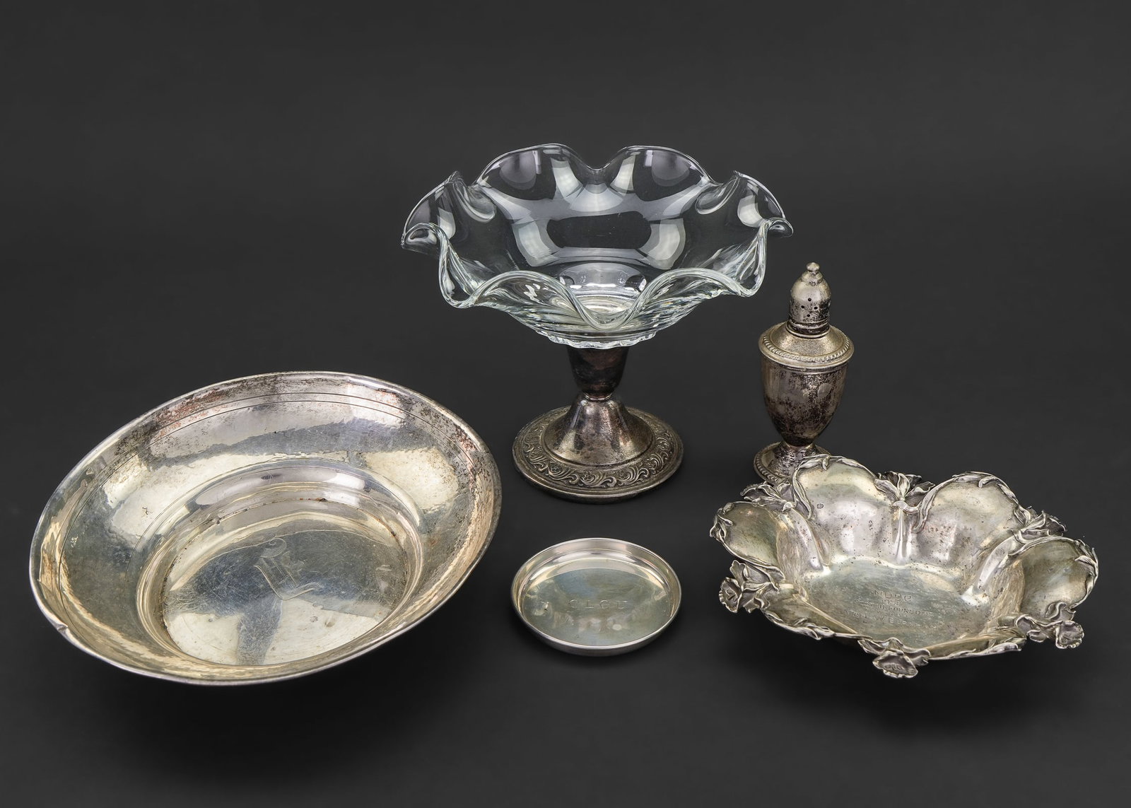 5 Sterling Silver Holloware Items: Lot of 5 sterling silver holloware items including Webster bowl, Lily decorated bowl, coaster, weighted candy dish, and a weighted salt shaker. 3"-8" 8.6 ozt. weighable