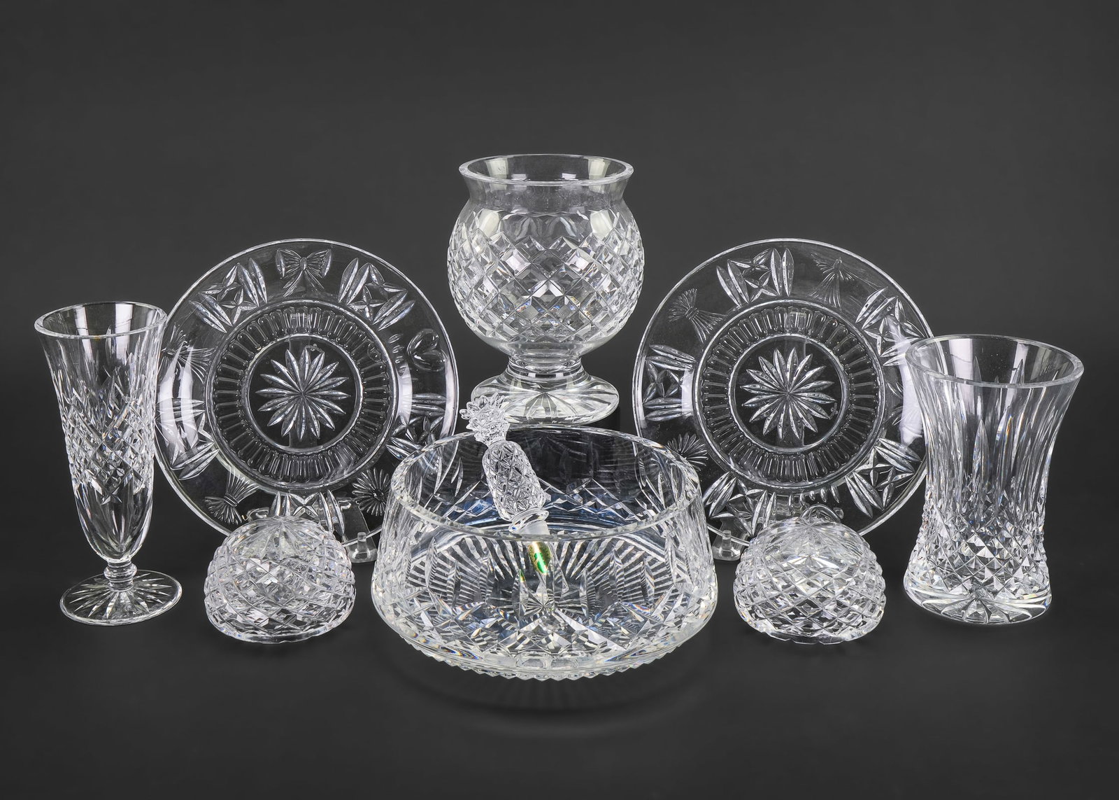 9 pcs. Waterford Irish Crystal Tableware: Collection of 9 pcs. of Waterford Irish crystal tableware including footed vases, Lismore serving bowl, bottle stopper, and a pair of hollow paperweights. 2.5"-7"