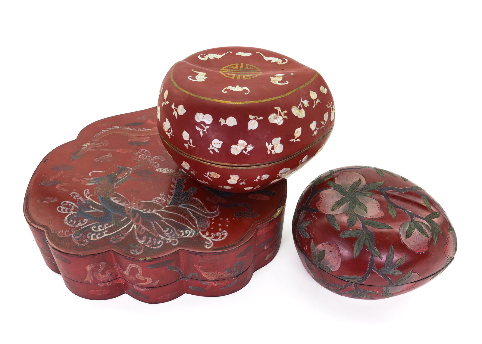 3 Chinese Red Lacquered Boxes: Group of 3 early 20th c. Chinese red lacquered boxes, two in the form of plums, one mother of pearl inlaid, the other in shaped form with dragon decorated lid dia. 9"-16"