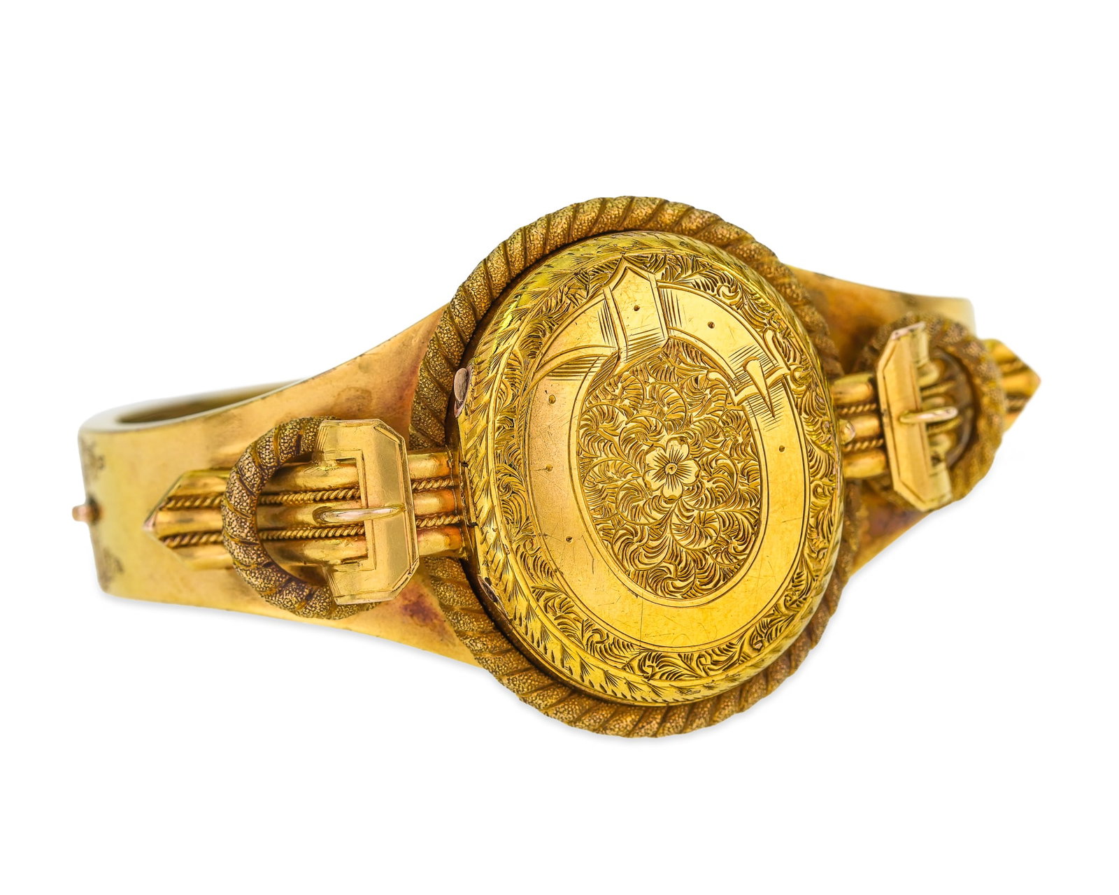 Victorian 14k Hair Locket Bangle: 14k yellow gold bangle with ornate buckle and tassel ends surrounding a oval hinged cover top with ornate engraving and rope edge surround. Interior with a woven hair underside. 32 grams t.w. 2 3/8"