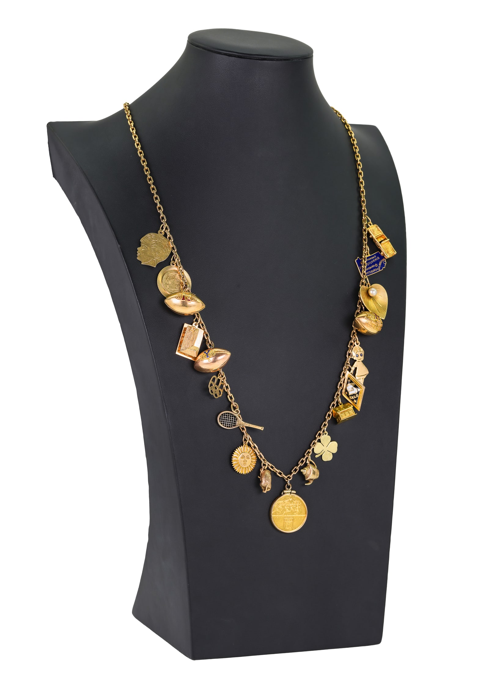 Yellow Gold Charm Necklace: Yellow gold charm necklace with 10k football, 14k disc, 14k building, 10k Olympic rings, 14k tennis racket, 14k sun, 9k bear, 1972 Olympic Munchen gold coin, 10k teapot, 18k house, 10k Yale