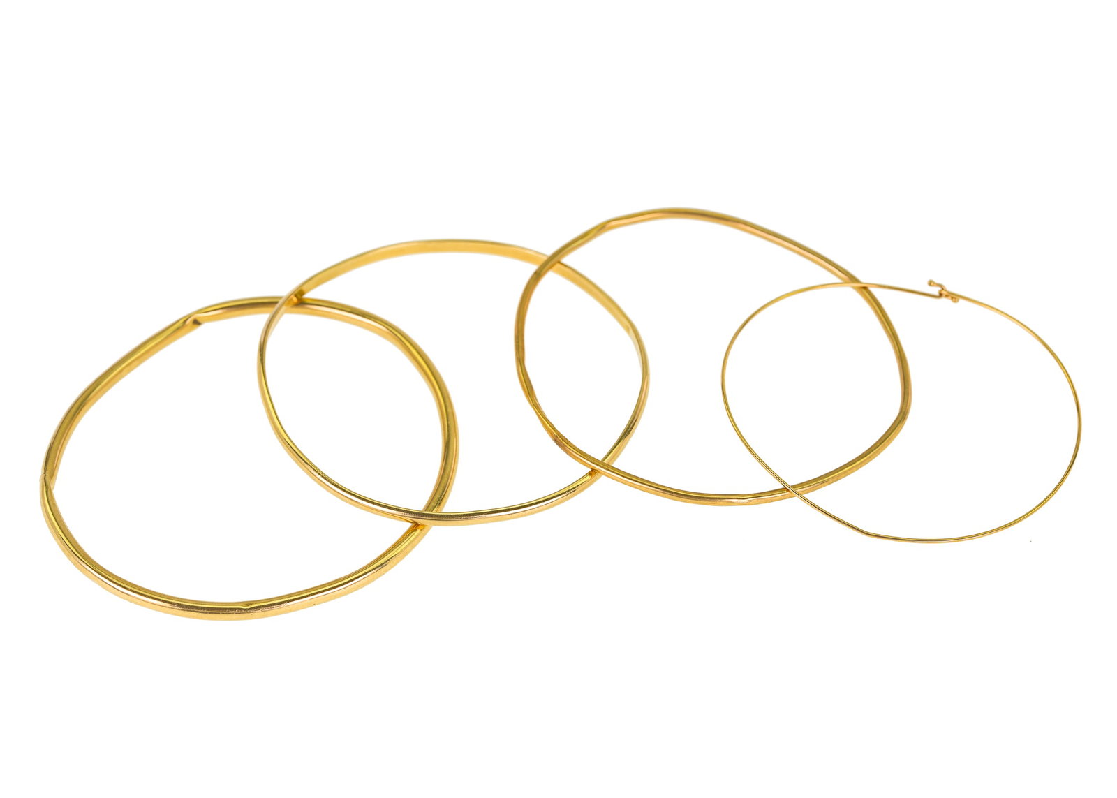 4 14k Bangles: A group of 4 14k yellow gold bangles, 3 hollow, one wire. 2 3/8" opening. Dents and not perfect round. 12.18 grams.