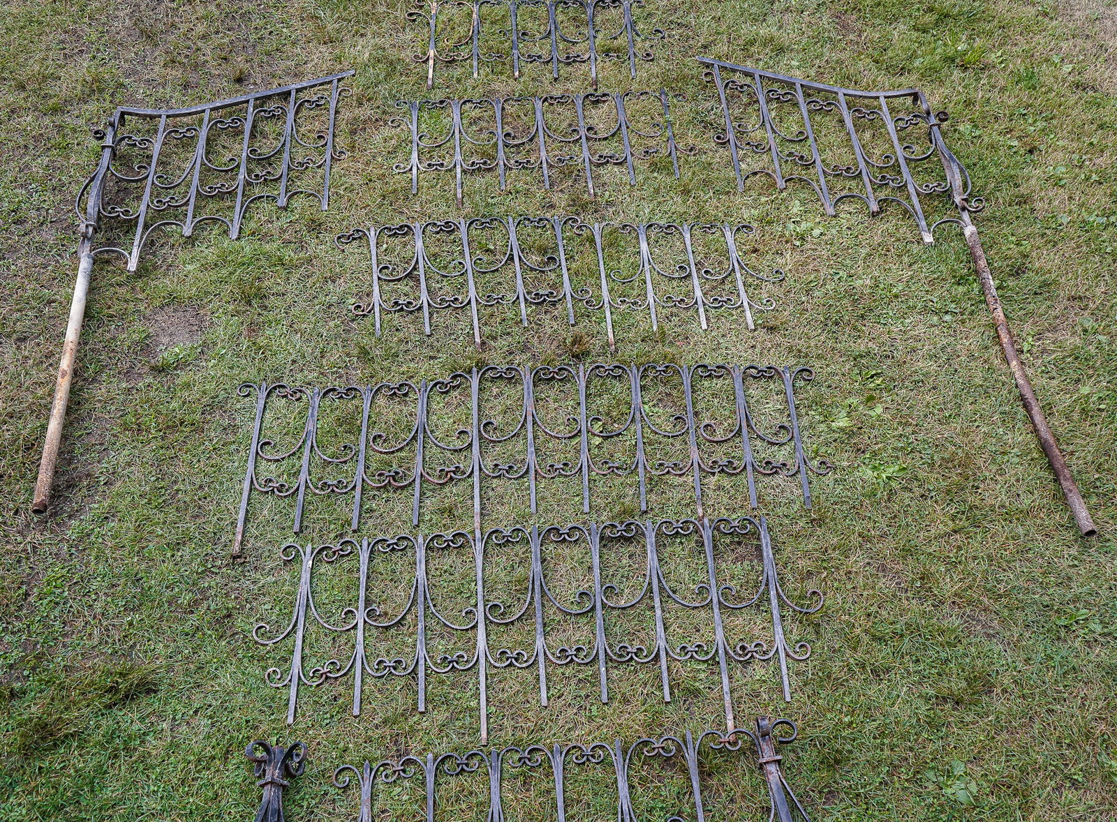 Large group of Wrought Iron Fencing/railings.: Large group of 19th c Wrought Iron fencing/railings with two newel posts, two descending rails, each 44" long 50" 50"w/Newell post ,60",65" 70" 80" (approx) minor bends and rust approx 27" high