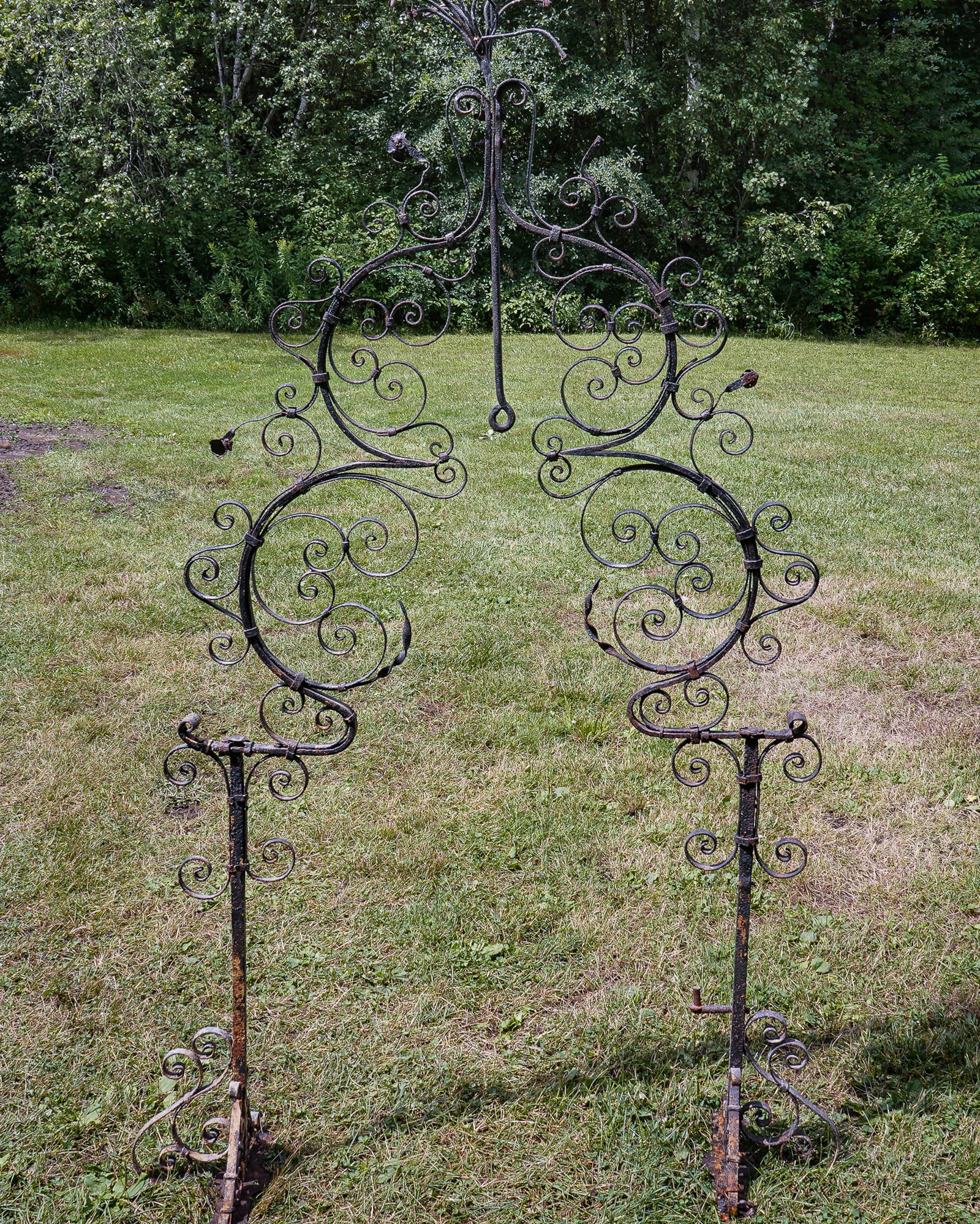 19th c Wrought Iron Arch: 19th c Intricate wrought Iron arch with hanging loop, remains of bouquet at top, and peg for hanging door (perhaps part of cemetery gates?) 78 x 50"