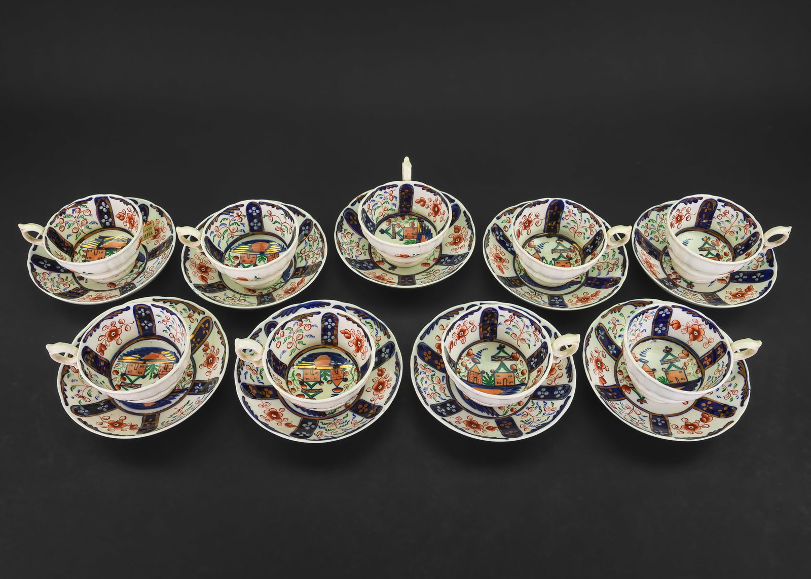 Set of 9 Gaudy Welsh Cups and Saucers: Set of 9 mid 19th c. English Gaudy Welsh cobalt and copper luster decorated porcelain cups and saucers, having old paper inventory label from "The Bryan Gallery Gloucester, Massachusetts" (operated