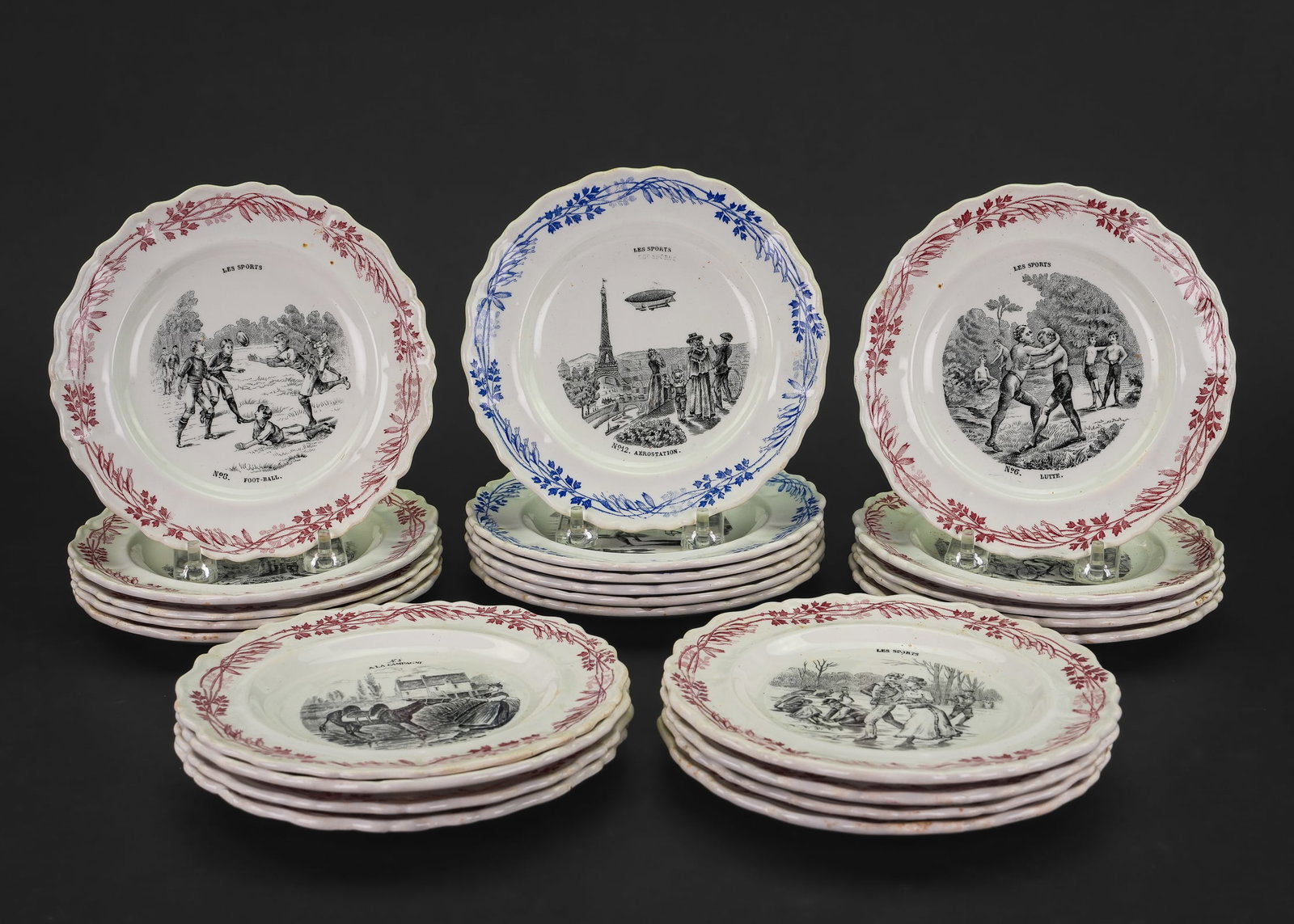 Creil et Montereau French Transferware Plates: Set of 24 late 19th c. Creil et Montereau "Terre de Fer" French transferware ironstone dessert plates depicting "Les Sports" including swimming, automobile touring, football, zeppelin/aeroships, horse