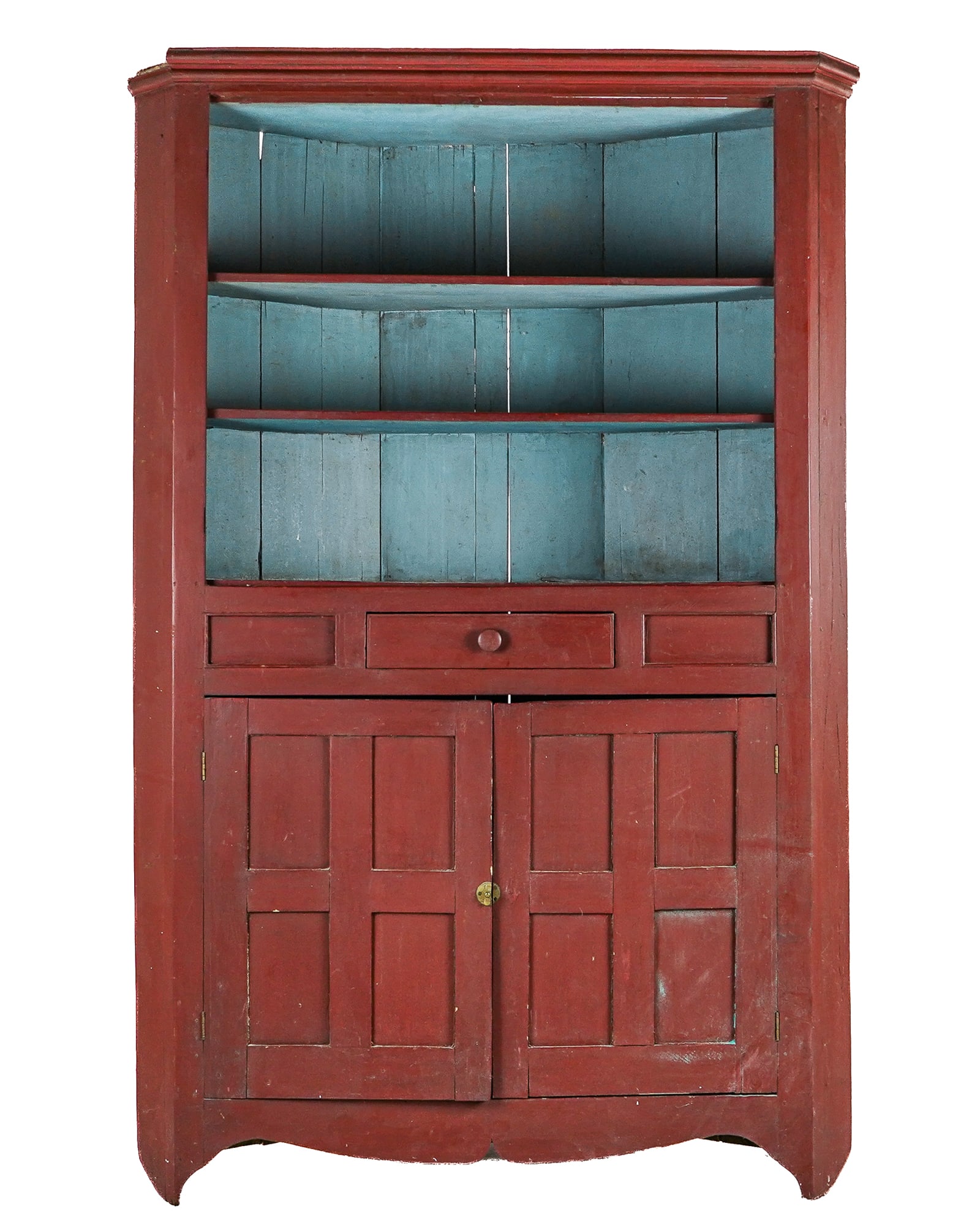 19th c Pine corner cupboard in later red paint.: 19th c Pine corner Cupboard in later red paint with central drawer over 2 paneled doors- scars from old hinges on a now open top, losses to back foot. 84 x 55 x 15"