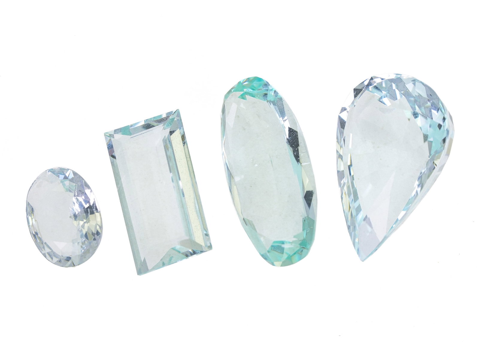 4 Loose Aquamarine Stones, 40+ CTS: 4 loose light blue aquamarines including 19 ct pear cut, 7 ct baguette, 13 ct oval, and a 3 ct oval.
