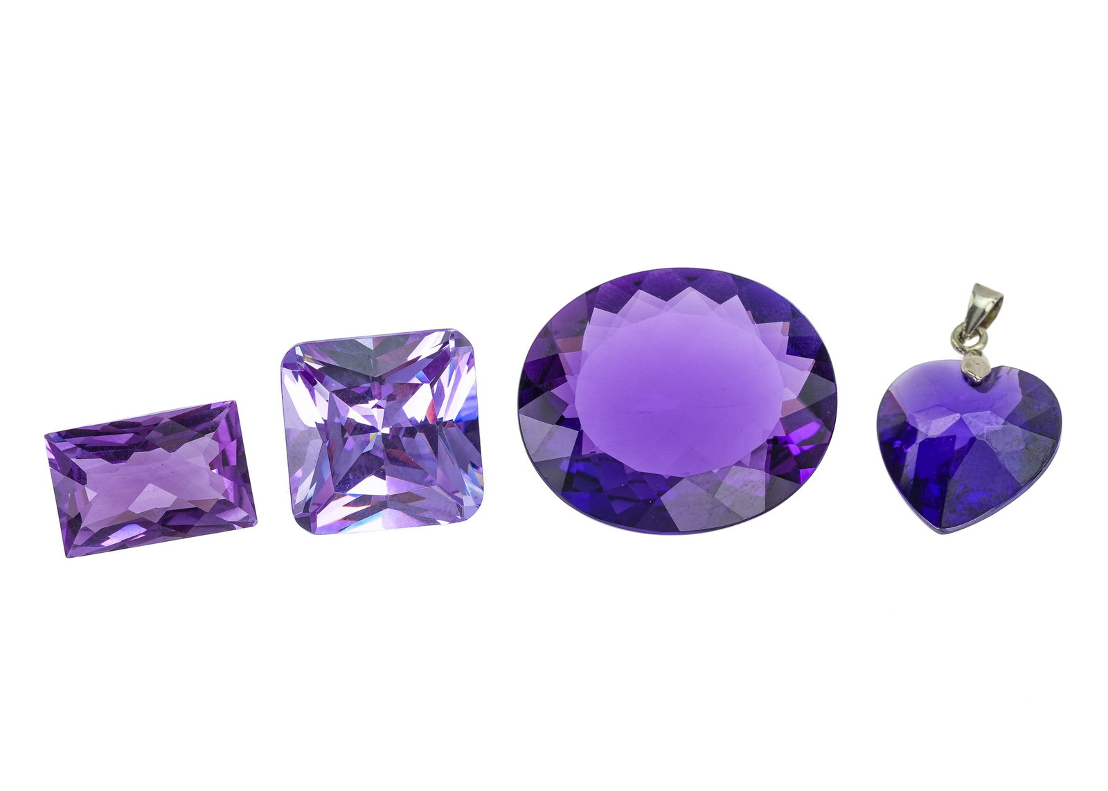 4 Loose Amethyst Stones: 4 loose amethyst including emerald cut 12.75 ct, heart cut pendant 18mm x 18mm x 8 mm with a 18k white gold loop, square cut 18mm x 18mm x 11mm, and oval cut 35mm x 25mm x 11 mm.