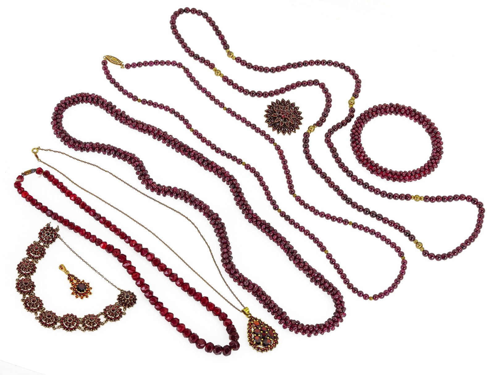 Garnet Jewelry: A collection antique garnet jewelry including gilt silver 1 1/2" long pendant. 27" bead necklace. 34" bead necklace with 3 gold bead sections. Cluster bead necklace and bangle. Silver mounted bracelet