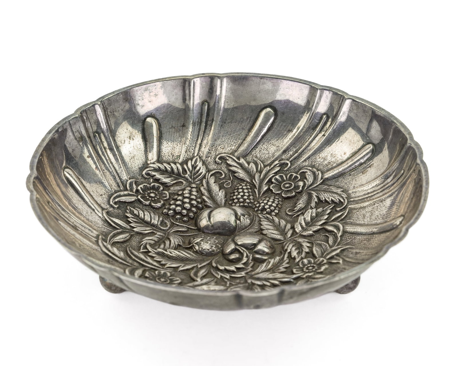 Kirk Repousse Sterling Silver Footed Bowl: S. Kirk and Sons Baltimore, MD "Repousse" pattern sterling silver bowl having highly detailed fruit and floral decorated center and scalloped edge, on 3 ball feet 1.5" x 5.75" 5 ozt.