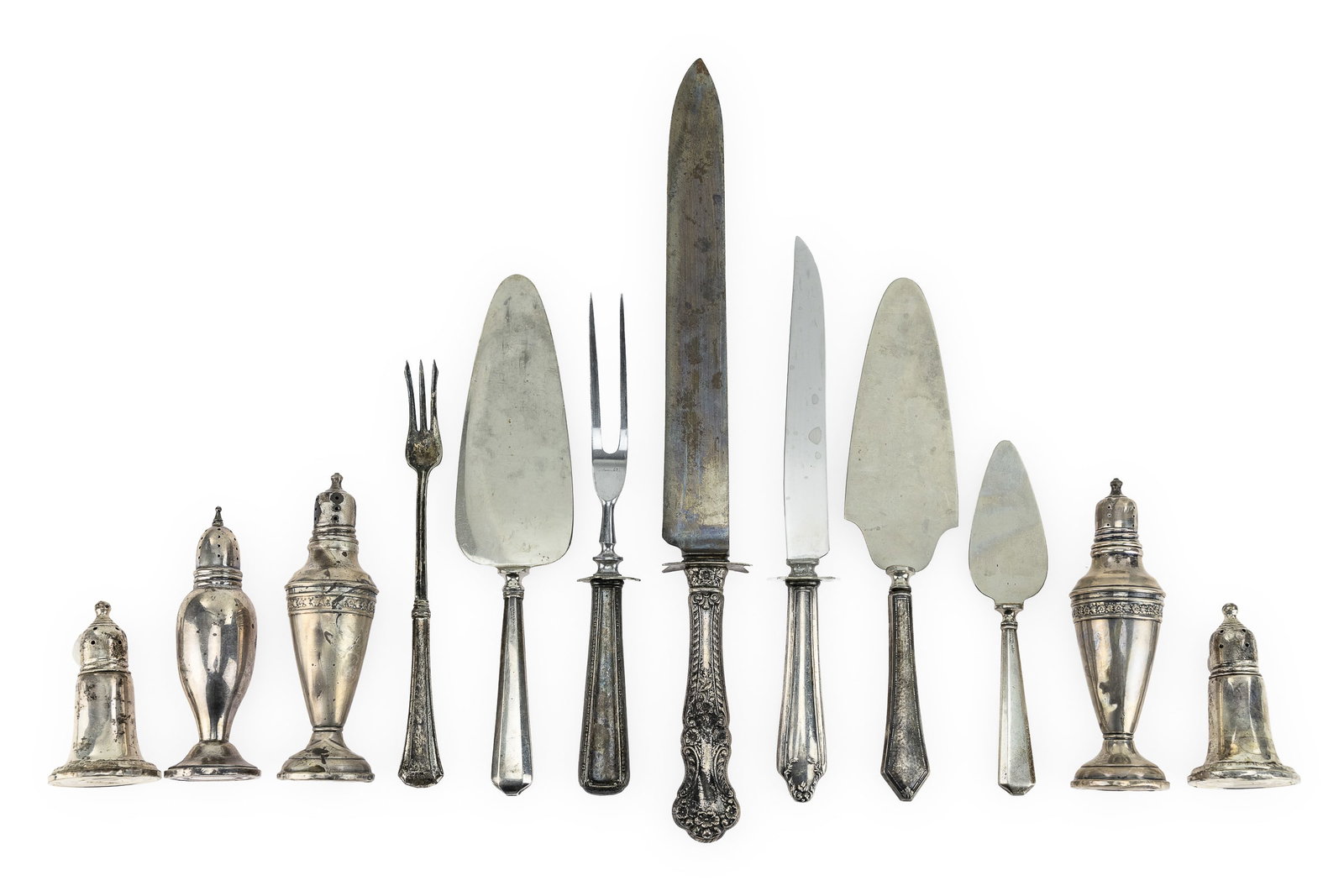 12 Sterling Silver Jacketed Items: Group of 12 sterling silver jacketed items including 5 weighted sterling salt and pepper shakers, and 7 sterling silver handled serving flatware pieces. 3.5" -14"