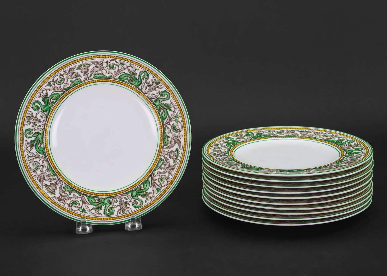 11 Wedgwood Florentine Luncheon Plates: Set of 11 Wedgwood "Florentine" Italian Renaissance motif English bone china dinner plates having green, yellow and black classical frieze borders with griffin and cherub figures among urns and
