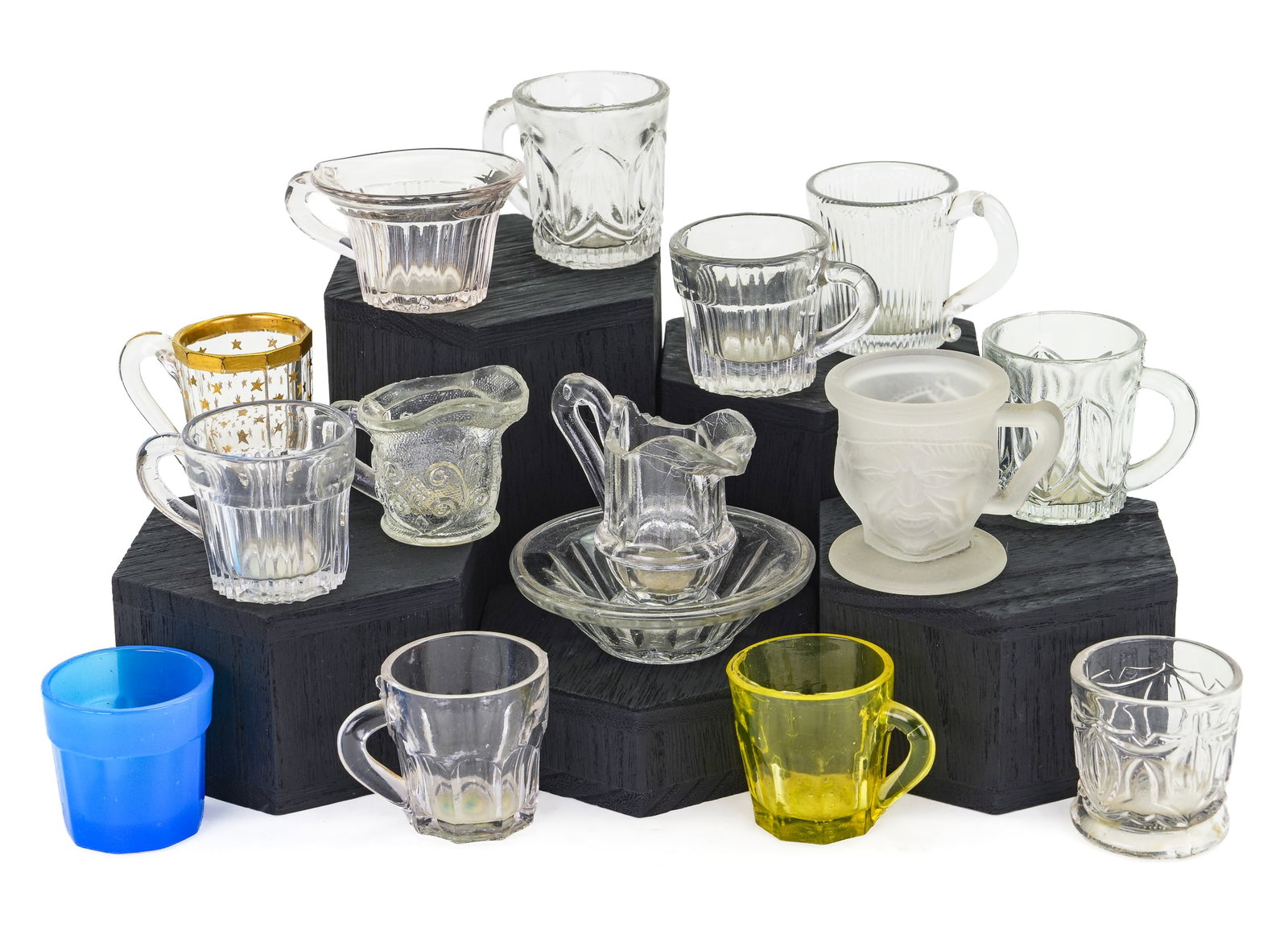 15 Miniature Pattern Glass Cups: 15 miniature pattern glass items including canary panel cup with handle, Miniature panel washbowl & pitcher. Blue clambroth cup. Ribbed with handle. And more. 2 1/2" to 1 1/4" high.