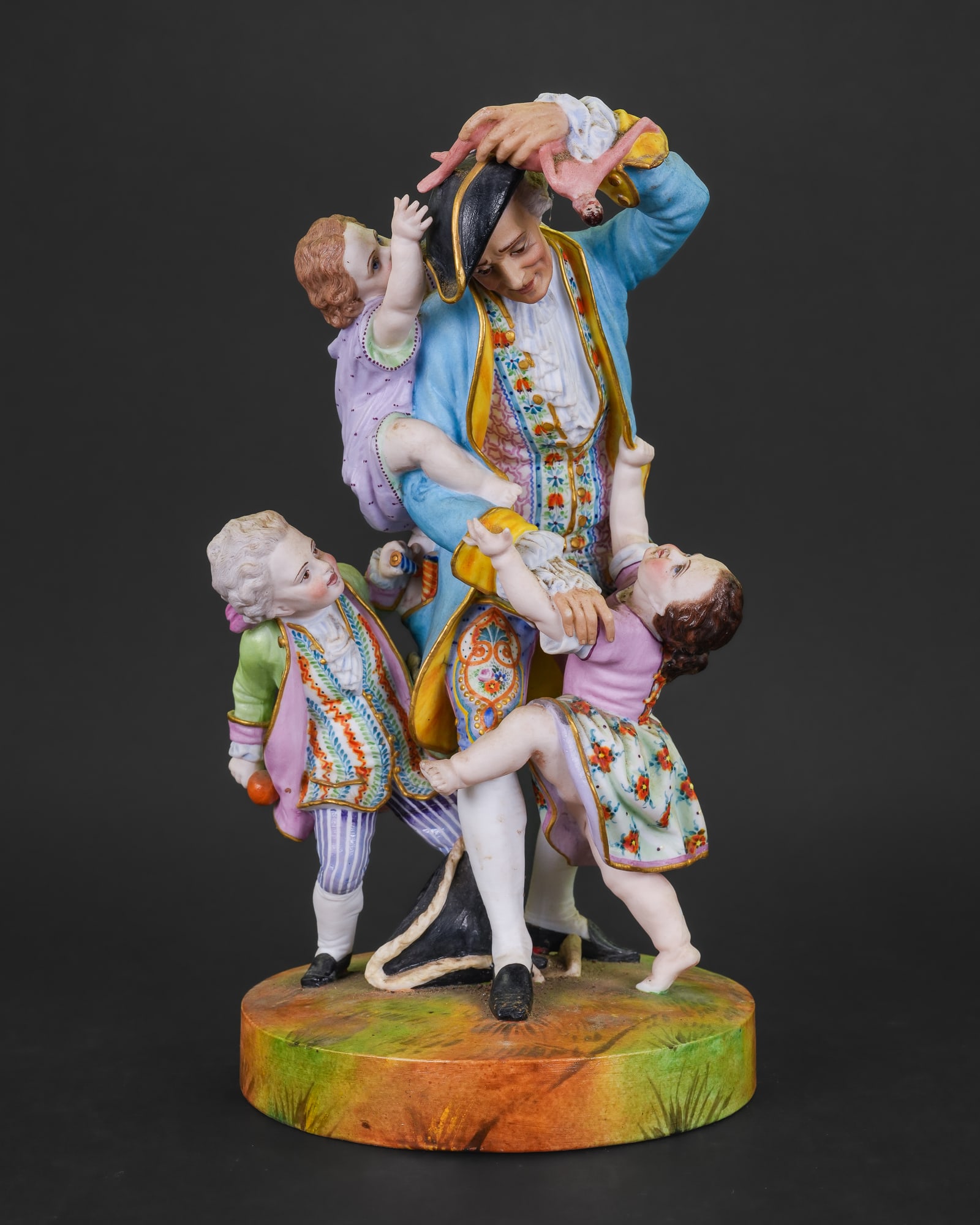 19th c. Jean Gille Bisque Porcelain Group: 19th c. Jean Gille European bisque porcelain figural group of gentleman holding doll surrounded by three children, highly detailed polychrome decoration repair to base 6.5" x 11"