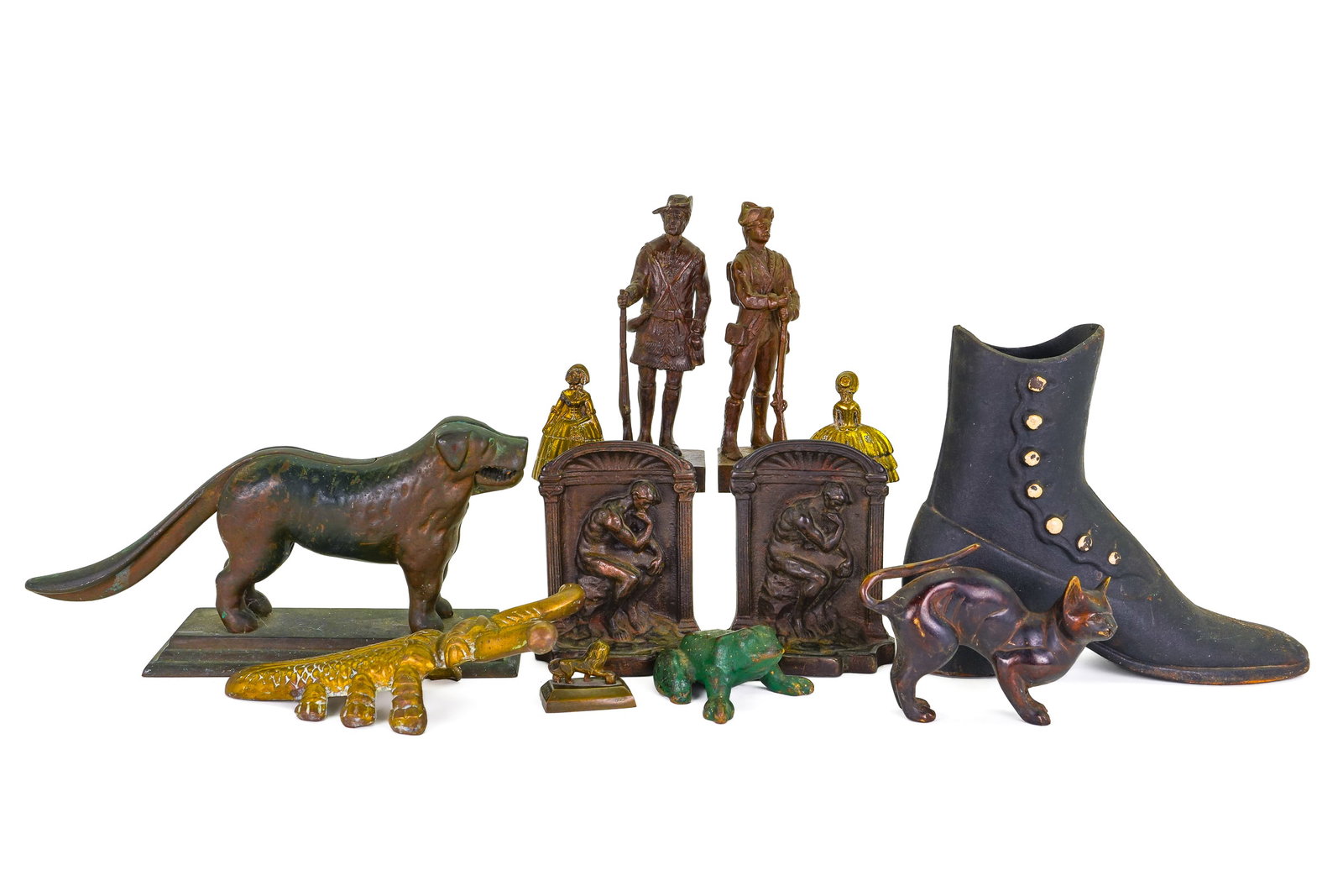 Cast Bronze and Iron Decorative Metalware: Group of 12 cast bronze and iron figures and decorative objects including a heavy bronze dog nutcracker, pair of cast bronze figures of Revolutionary war era soldiers, brass beetle boot jack, pair of 