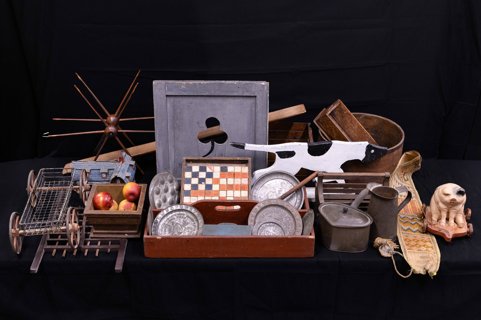 Country Table Lot: Country woodenware, tin, including carrier in red paint, stone fruit, painted blocks, 1880 hand stitched bell cord, shutter, grain measure, tin ABC plates, etc