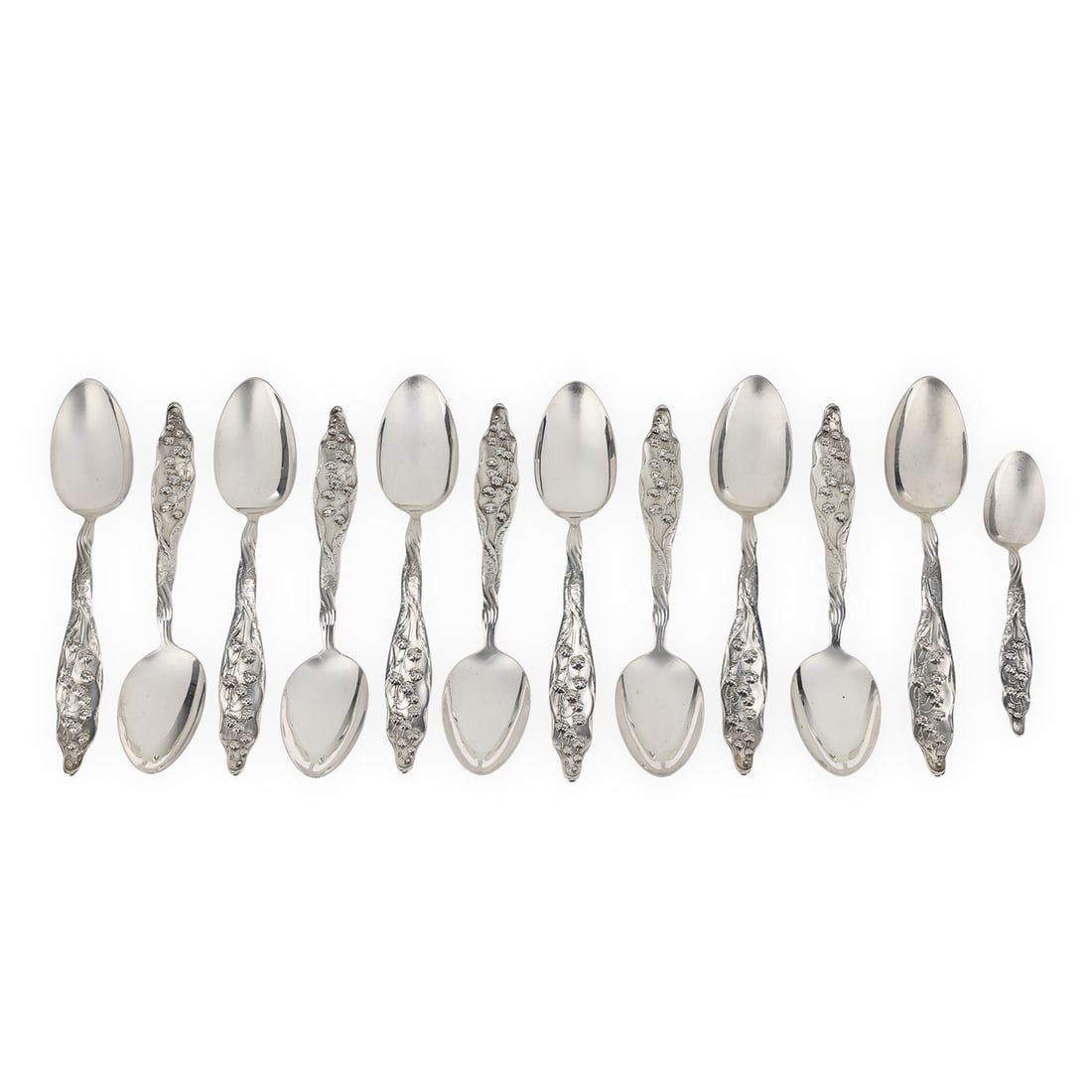 12 Whiting Lily of the Valley Sterling Spoons: 12 outstanding ca. 1900 Whiting 'Lily of the Valley' pattern Art Nouveau naturalist motif sterling silver spoons including 11 tablespoons with Gothic script "Mc" monogram on the reverse, accompanied