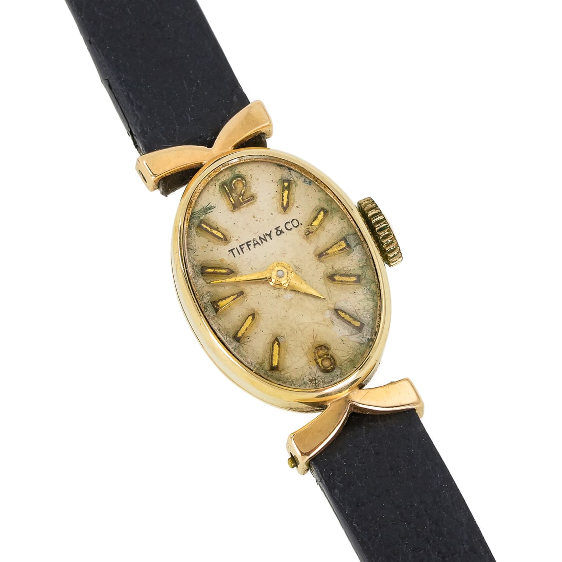 Tiffany 14k Ladies Wrist Watch: Vintage 14k yellow gold Tiffany & Co oval yellow gold wrist watch. Silver face, gold hour marks, 13 mm wide. Black leather band. Wear to face. Does not appear to be running.