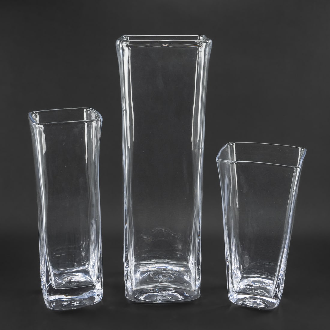 3 Simon Pearce Square Crystal Vases: 3 signed Simon Pearce Quechee, VT artisan hand blown "Woodbury" square vases having signature quatrefoil pontil marks.ht. 11", 13.5", 18.5"