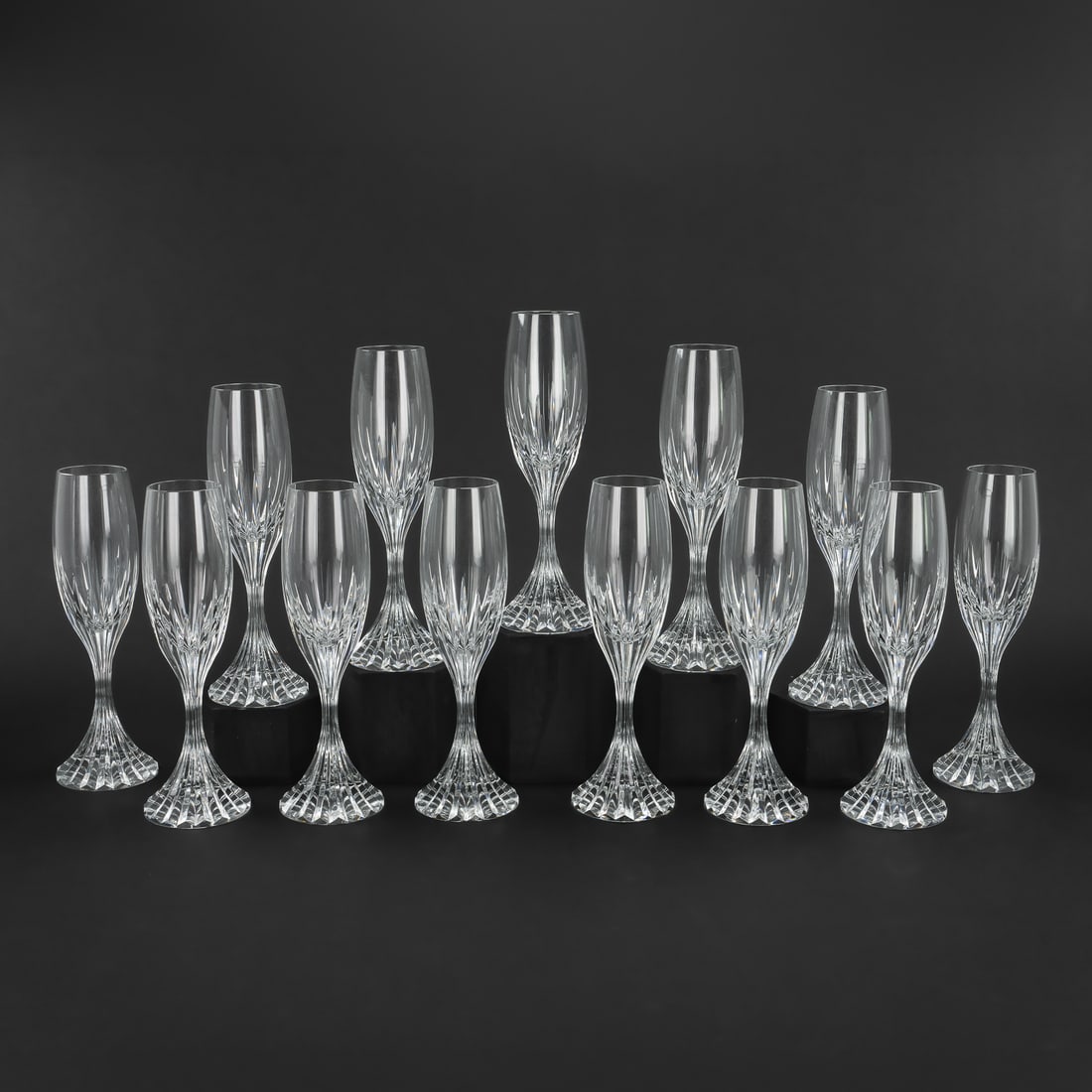 13 Baccarat Massena Champagne Flutes: Set of 13 Baccarat "Massena" pattern signed French crystal champagne flutes with solid rigid bases, overall excellent condition. 8.5"