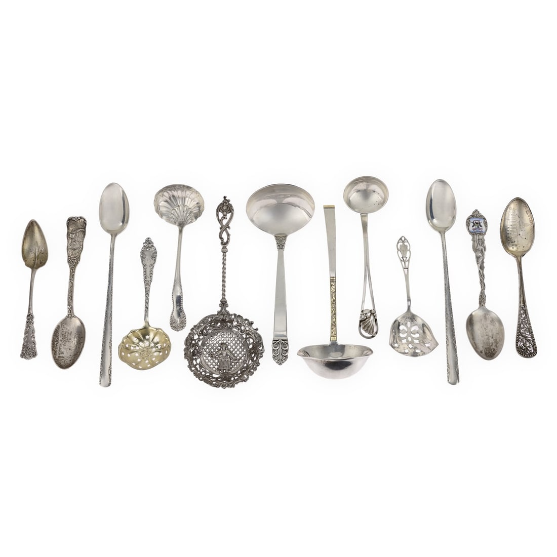 12 pcs. Assorted Sterling Silver Flatware: 12 pcs. of assorted sterling silver flatware including 3 mid century sauce ladles, Victorian era souvenir spoons, etc. 5"-7.5" 14.2 ozt.