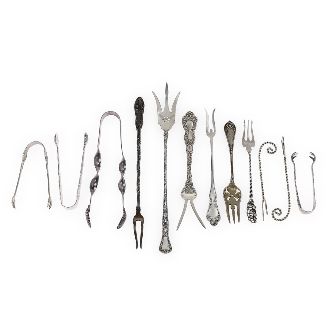 12 pcs. Unusual Victorian Sterling Flatware: 12 pcs. of assorted unusual sterling silver serving flatware including lettuce and olive forks and several sugar tongs 3.25"-9" 7.9 ozt.