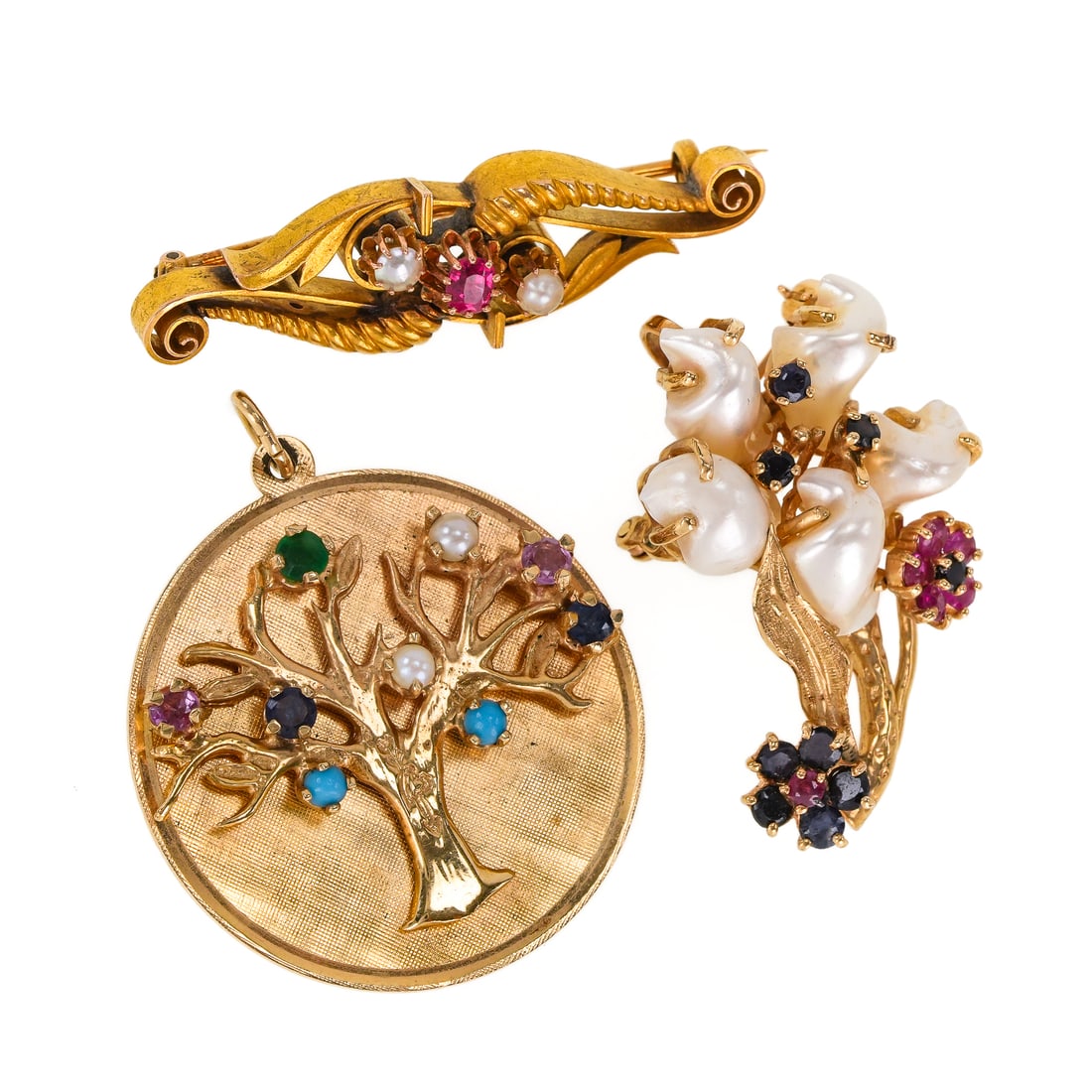 3 Pieces 14k Jewelry: 3 pieces 14k yellow gold jewelry including a floral form brooch pin with 5 baroque pearls, 9 small sapphires, & 6 small rubies, 1 1/4" long. Round charm / pendant with tree design on front and small