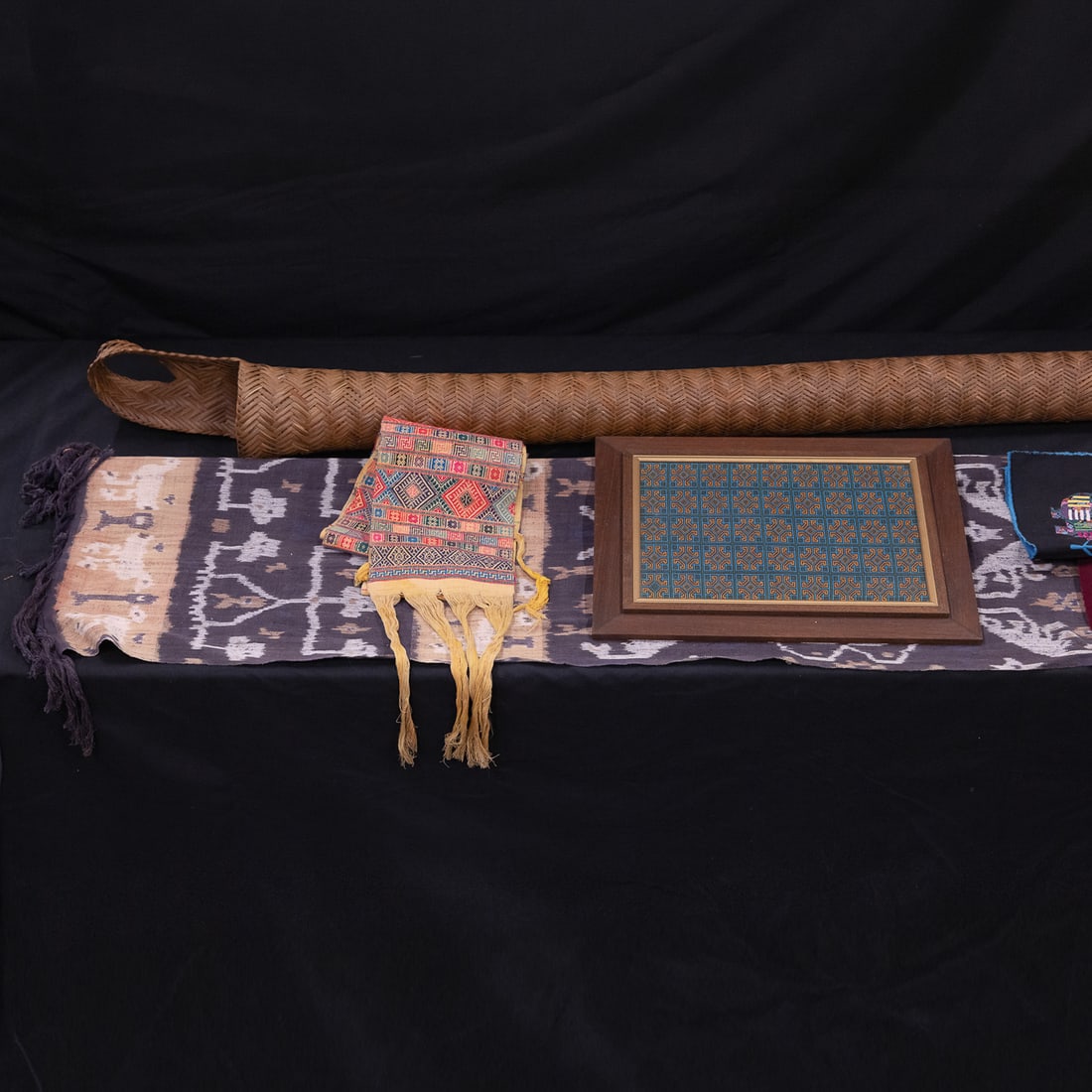 Ethnographic Materials: Textiles from Hmong people, Indonesia, Panama, Philippines, 1970's Columbian hooked rug, 6' Venezuelan sebucan basket used to squeeze liquid from cooked cassava, Bhutan waist sash (basket is six feet