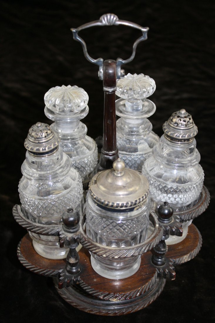 ca. 1810 Thos. Watson & Co. Sheffield gadrooned: ca. 1810 Thos. Watson & Co. Sheffield gadrooned sterling silver mounted 5 pc cut glass caster set in carved mahogany revolving frame 10”