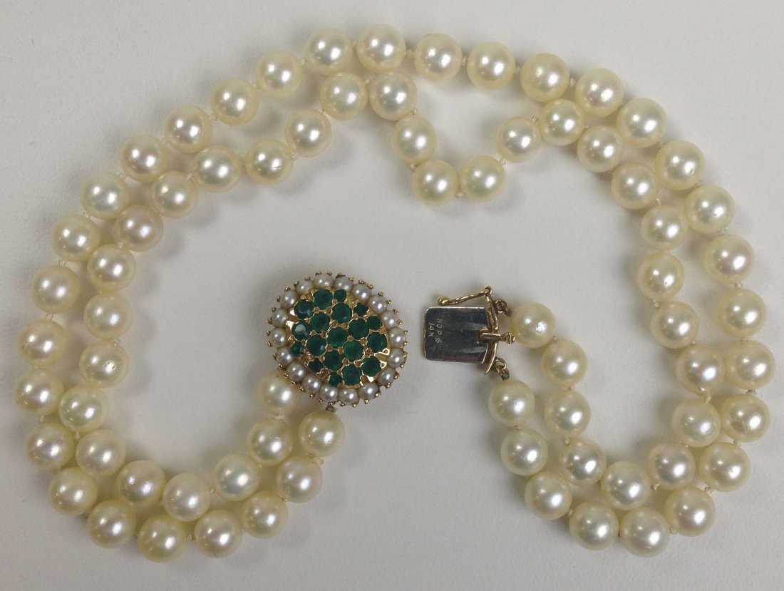 14k y.g. double strand pearl choker 12½"L each. Oval: 14k y.g. double strand pearl choker 12½"L each. Oval clasp having 19 natural emeralds with seed pearl surround.