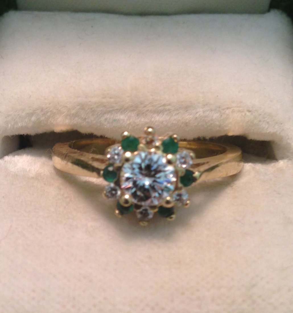 14k y.g. ladies floral form cocktail ring having modern: 14k y.g. ladies floral form cocktail ring having modern rd ut .75ct surrounded by 6 sm rd cut diamonds & 6 small rd cut emeralds. Size 8¼.