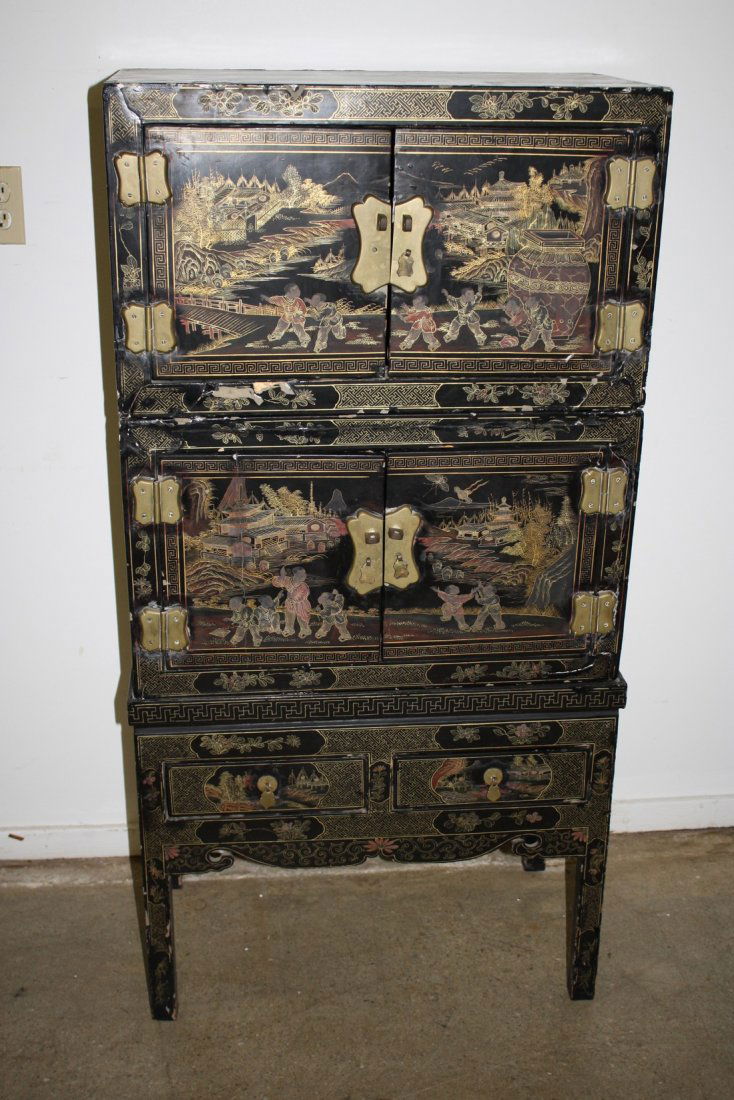 Chinese painted lacquered three sectional cabinet on: Chinese painted lacquered three sectional cabinet on legs, two cupboard compartments over two drawers, late 19th or early 20th c. 27"w x 53"h x 15"d.