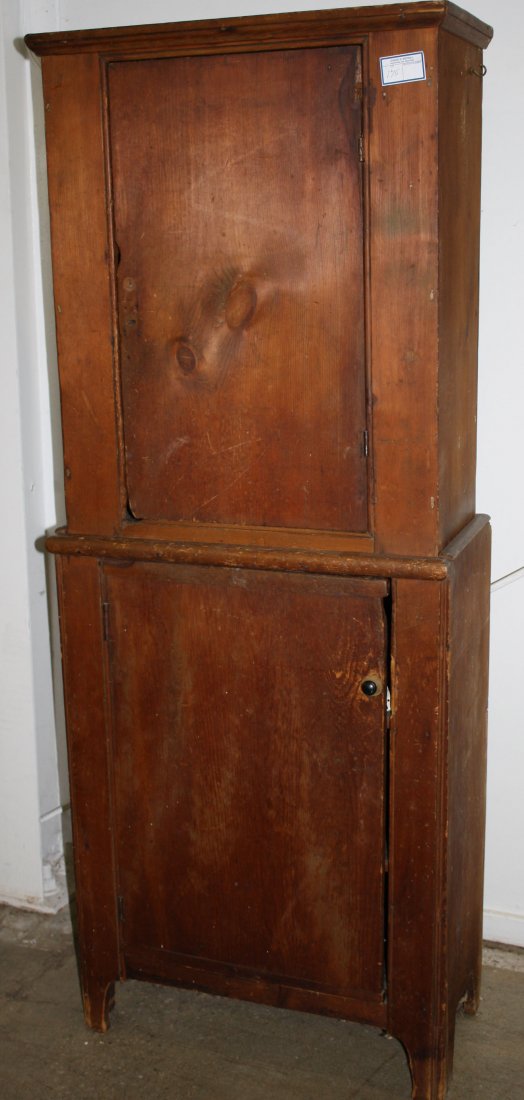18th/19th c small pine two part step back cupboard on: 18th/19th c small pine two part step back cupboard on shaped base. 27"w x 68"h.