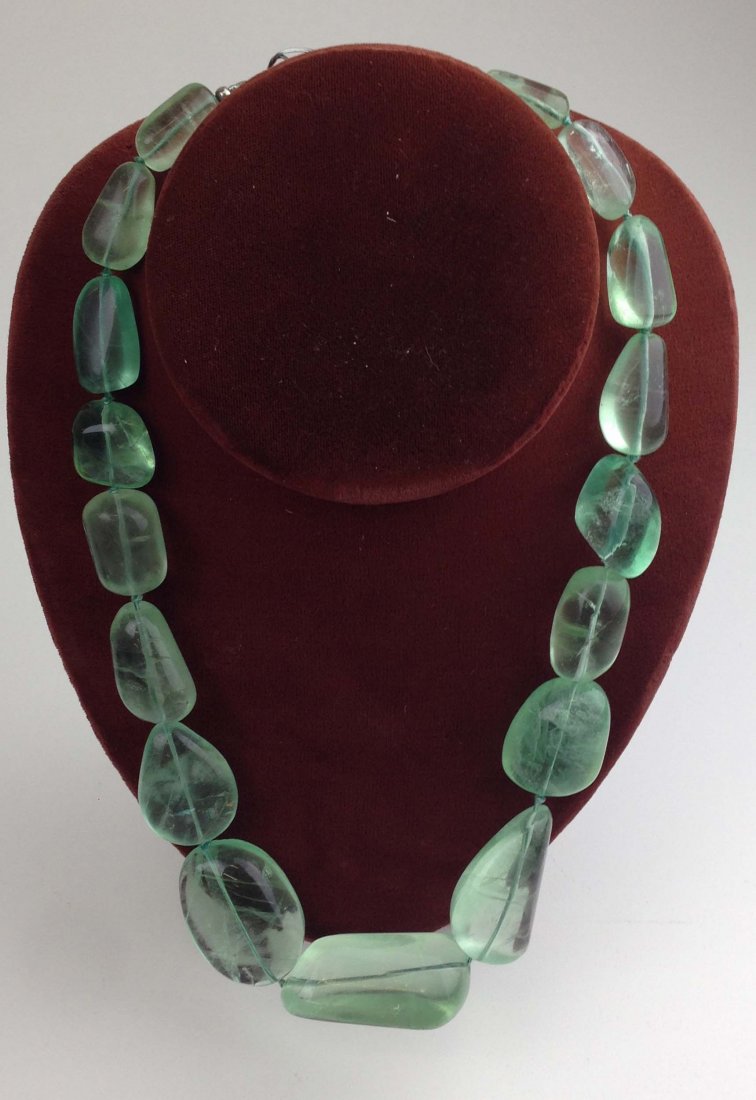 Graduated oval aquamarine polished nugget necklace: Graduated oval aquamarine polished nugget necklace having 17 large oval stones from 20mm to 46 mm in length. pool of light type. Sterling clasp.