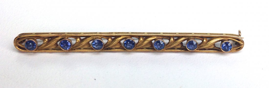 14k y.g. bar pin having 7 round cut bezel set sapphires (1 of 2)