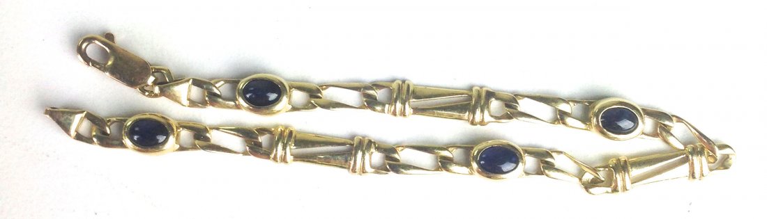 14k y.g. chain bracelet having 4 bezel cut set oval: 14k y.g. chain bracelet having 4 bezel cut set oval polished small sapphires. 7"l. 7.3grams total wt.