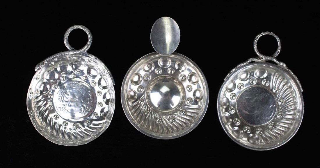 three 19th c. European silver wine tasters inset with: three 19th c. European silver wine tasters inset with old coins, two with twisted snake handles 4" x 3"