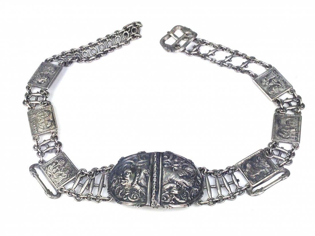 fine silver belt & buckle mkd "H. Moller .830: fine silver belt & buckle mkd "H. Moller .830 Trondhiem" (Henrik Moller Norway ca. 1900) having buckle w/dog & demon decoration 4"x2", 6 panels selt in belt each of various torture or death scenes, cl
