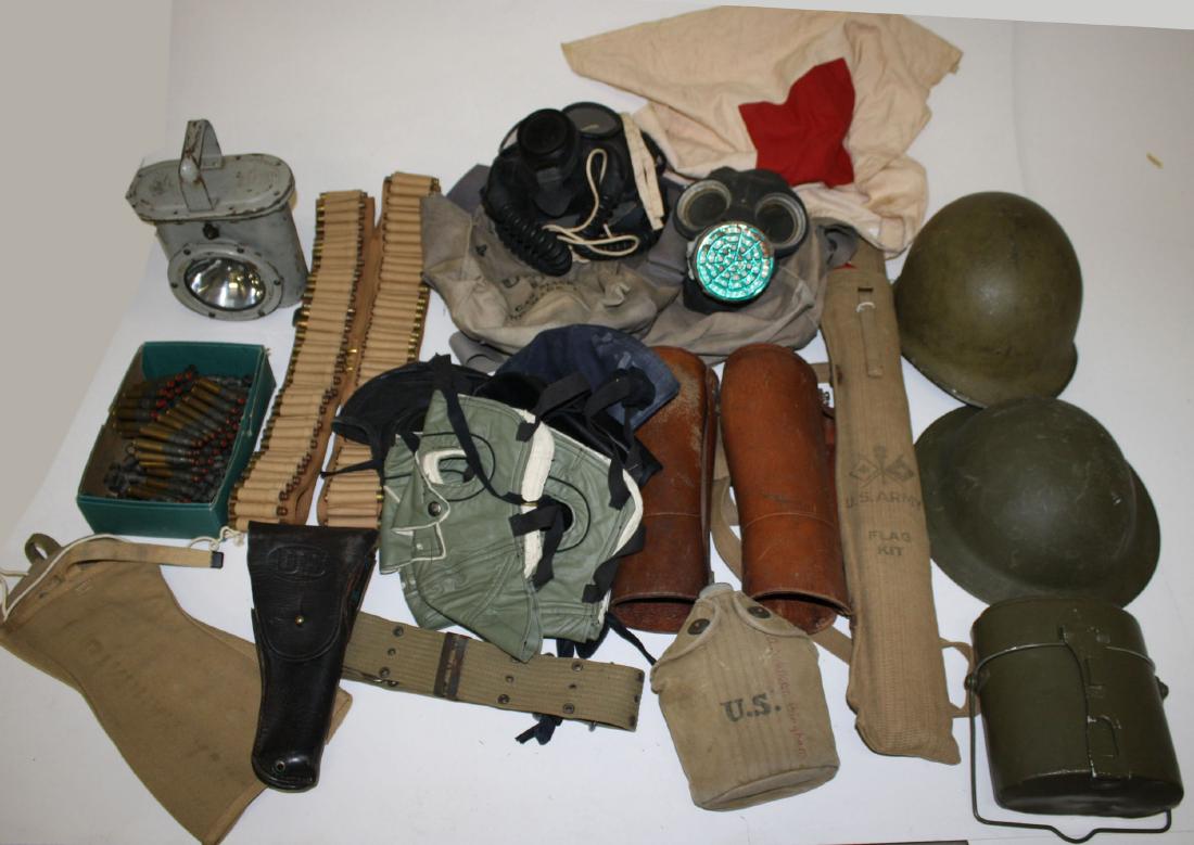 Large lot of US Military accessories: WWI & WWII US Helmets, leather and canvas gaiters, Signal corp flags, ammo belts, two US Navy Gas masks, Military belts, canteens, flashlights, Naval hats